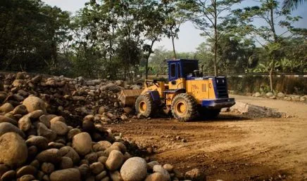 bulldozer pushing rock